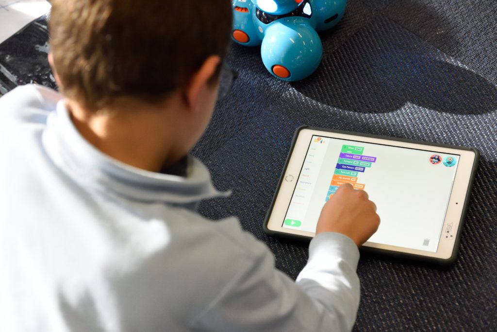 child playing a word game on a tablet